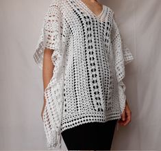 Beach lace tunic, white color, made of mercerized cotton. The pattern gives a nice ethnic look. The width is adjustable, as there are two strings on both sides (Romanian cord made also by hand) of the same thread. It can be worn as a short caftan, a beach dress, or swimsuit cover up. The cotton and the lace pattern give a pleasant cooling effect, helping to enjoy the summer days.  Made in smoke free, pet friendly environment.  Length: 27'' or 68 cm Width: 31'' or 78 cm Neck opening depth: 7.5'' White Crochet Lace Top For Beach Cover-up, White V-neck Crochet Dress For Beach, White Crochet Beachwear Cover-up, White Poncho For Spring Beach Cover-up, White V-neck Summer Crochet Dress, White V-neck Crochet Dress For Summer, White Crochet Bohemian Cover-up, White Crochet Lace Dress For Beach Cover-up, White Crochet Lace Beach Dress For Vacation