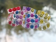 Resin Smiley Rings! PERFECT for gifts!  If you do not see the color you are wanting I am sold out of that color.  please also know blue and turquoise are different if you order blue is is a dark blue.  🛑 If you select rainbow and would like the colors in order please message me and be advised smileys will be smashed all together depending on the size you order smaller sizes will be more squished together as bigger sizes will fit all colors. 🛑 Violet will be pink if you choose rainbow in order selection.  Pricing is for one ring only.  I have been getting lots of requests for rings like the picture so I added a personalization spot for you to select multiple color smiley faces ❤️ I hope that helps.  I'm also a message away if you have any questions.  IMPORTANT FOR CHOOSING RING SIZE :)  - Rainbow Smiley Face, Resin Gifts, Mushroom Ring, Rings Etsy, Resin Design, Resin Ring, Pretty Rings, One Ring, Doll Furniture