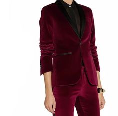 This wine-red tuxedo pantsuit is elegantly tailored with a classic black lapel and finished with a luxuriously glossy sheen, evoking the refined luxury of a bygone era. Every seam and contour of this exquisite garment is displayed with finesse, perfect for making a sophisticated statement. Wine Red Elegant Tuxedo Blazer with Black Lapel for evening wear or dinner. Peak lapel; single-breasted button front. Basted sleeves. Chest welt pocket. Flap pocket detail. Fitted. Straight hem. Polyester 100% Red Tuxedo, Tuxedo Blazer, Peak Lapel, Bygone Era, Ankle Length Pants, Pocket Detail, Wine Red, Flap Pocket, Evening Wear