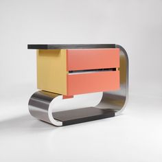 an artistically designed sideboard with two different colored drawers on it's sides