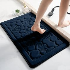 a person standing on top of a bath mat