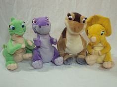 five stuffed animals are lined up in a row