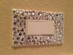 a light switch with lots of crystal stones on it