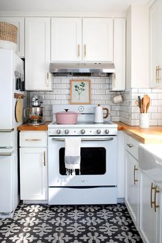 a white stove top oven sitting inside of a kitchen