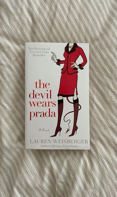 the devil wears prada by lauren eiserer is on a bed with white sheets