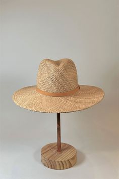 Straw panama hat with a tan leather band. Summer Fedora Panama Hat Made Of Palm Leaf, Brown Leather Fedora, Brown Flat Crown Straw Hat For Vacation, Summer Fedora In Toquilla Straw, Everyday Summer Fedora In Toquilla Straw, Everyday Summer Hats With Flat Crown, Everyday Summer Hat With Flat Crown, Summer Everyday Toquilla Straw Fedora, Brown Straw Panama Hat With Curved Brim