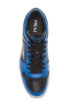 Trims in a bold primary color zip around the silhouette of this low-top leather sneaker featuring a perforated toe and three versions of the iconic Prada logo. Lace-up style Removable insole Leather upper/leather and textile lining/synthetic sole Made in Italy Men's Designer Shoes Blue Leather Sneakers With Logo, Modern Custom Leather Sneakers With Logo, Blue Sporty Sneakers With Embossed Logo, Sporty Blue Sneakers With Embossed Logo, Blue Low-top Calf Leather Sneakers, Blue Leather High-top Sneakers With Perforations, Designer Leather High-top Sneakers With Perforated Toe Box, Modern Blue Sneakers With Perforations, Luxury Blue Sneakers With Perforated Toe Box