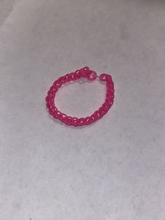 a pink bracelet on a white surface