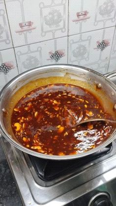 a pot filled with food sitting on top of a stove