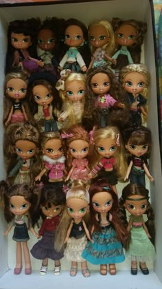 a box filled with lots of different types of dolls