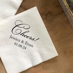 two personalized napkins sitting on top of a wooden table