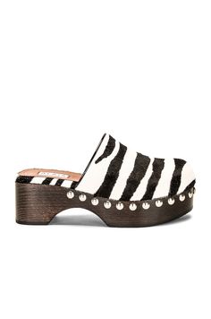 Find ALAÏA Flat Clog In White on Editorialist. ALAÏA Flat Clog in White Dyed calf hair upper with rubber sole and silver-tone hardware. Wooden midsole. Made in Italy. Fur Origin: Italy. Leather lining and footbed. Studded accent trim. Round toe. Approx 57mm/ 2.25 inch heel Approx 33mm/ 1.3 inch platform. ALIA-WZ78. AA3M050CK164. About the designer: The late Azzedine Alaïa had a comprehensive understanding of the female form, thanks to an education in sculpture from École des Beaux-Arts. Revered for his bodycon silhouettes that defined the aesthetic of Paris in the ‘80s, the Tunisian designer was also known for his intricate footwear, statement bags and laser-cut accessories. Calf Leather Clogs With Removable Insole And Closed Toe, Closed Toe Calf Leather Clogs With Removable Insole, Calf Leather Clogs With Removable Insole, Calf Leather Closed Toe Clogs With Removable Insole, Calf Leather Clogs With Rubber Sole And Round Toe, Azzedine Alaïa, Accent Trim, Azzedine Alaia, An Education