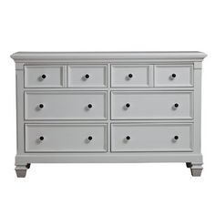 a white dresser with six drawers and two doors