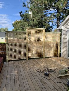 a wooden deck with an electric fence and power tools on the ground next to it