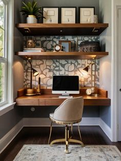 a desk with a computer on top of it in front of a window and a rug