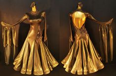 two gold dresses on display in front of a black background