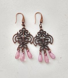 Beautiful ornate chandelier drop earrings made with antique copper filigree findings and pale rose pink Czech pressed glass teardrops; finished with red copper laser cut effect ear hooks. A gorgeous classic Boho look that's ultra feminine with a touch of mystery. ABOUT - Welcome to RicePaper Jewels. It's my pleasure to share what I love to do which is to beautify and uplift through art. When I make a piece, I use the power of positive intention because I believe that what you think when you crea Pink Copper Drop Earrings, Pink Teardrop Chandelier Earrings, Nickel Free, Teardrop Chandelier, Simple Gift Wrapping, Red Copper, Sparkly Things, Rare Crystal, Simple Gifts, Boho Look