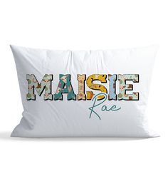 a white pillow with the word'masie face'printed in multicolored letters