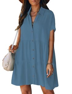 a woman wearing a blue shirt dress and brown hat with her hand on her hip