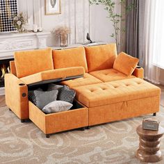 an orange sectional sofa with storage underneath it