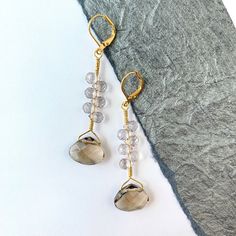 Dynamic lightweight dangling earrings that will quickly become your favorite everyday earring. These smoky gray faceted crystal statement earrings offer a unique understated finishing touch to an outfit. Very lightweight! Thanks for looking! ~2.5-inch drop ~Gold-plated, nickel-free comfortable lever backs that offer security to prevent loss Gray Drop Earrings For Pierced Ears, Gray Dangle Earrings For Pierced Ears, Gray Drop Earrings, Gray Dangle Earrings With Ear Wire, Crystal Statement Earrings, Jewelry Techniques, Holiday Earring, Jewelry Show, Beaded Purses