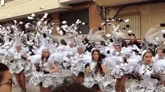 a group of people that are standing in the street with some kind of costume on