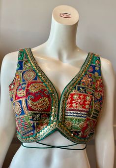 A green color embroidered blouse  Product details Fabric -Georgette Embroidery - Silk threads and sequins Bust size 34" Waist 28" Can be tailored to fit 36" For extra charges Green Embroidered V-neck Blouse, Sleeveless Multicolor Choli With Floral Embroidery, Multicolor V-neck Blouse For Party, Sleeveless Multicolor Floral Embroidery Choli, Sleeveless Multicolor Floral Embroidered Choli, Fitted Multicolor Embroidered Top With Intricate Embroidery, Embellished Multicolor Embroidered Choli, Summer Multicolor Choli With Floral Embroidery, Fitted Multicolor Embroidered Top