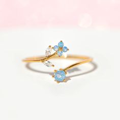 From it's beautiful vine-like features to subtle whimsical elements, our Wandering Blossom Adjustable Ring is the perfect delicate piece to add to your collection. This adjustable ring features our best-selling blossom design and is coupled with a pair of cubic zirconia leaves and an opalescent stone at the base. 18k g Cute Promise Rings, Pretty Jewelry Necklaces, Magical Jewelry, Blossom Design, Jewelry Lookbook, Fancy Jewelry, Rings For Girls, Cute Rings, Pretty Rings