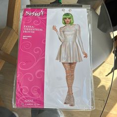 a barbie doll wearing a silver dress and laces on her legs, in a plastic package