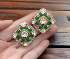 Polki Kundan Stud Earrings, inspired by Sabyasachi, feature a blend of emerald and ruby Kundan designs. Adorned with moissanite Polki diamonds and set in gold, these designer statement pieces showcase exquisite Indian craftsmanship. Perfect as a luxurious gift, they add timeless elegance to any jewelry collection. *𝐏𝐑𝐎𝐃𝐔𝐂𝐓 𝐃𝐄𝐓𝐀𝐈𝐋* * Material: Brass * Plating: Gold Plated * Stone: Semi Precious Kundan & Polki *𝐃𝐈𝐌𝐄𝐍𝐒𝐈𝐎𝐍𝐒* * Earrings- Weight: 10 gm Each, Length: 1.1 Inches, Designer Green Earrings For Gift, Green Earrings For Anniversary And Festivals, Designer Green Jewelry For Anniversary, Green Earrings For Formal Diwali Occasion, Green Formal Earrings For Diwali, Polki Studs, Sabyasachi Jewellery, Polki Earrings, Earrings Emerald