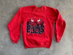 --  Vintage 1990s Chicago Bulls NBA Red Sweatshirt --  Very good overall condition with no issues of note --  50/50 poly cotton blend --  Size tag Youth Large (adult Extra Small), but please see below for measurements --  Thanks for looking, and have a fantastic day! MEASUREMENTS Bust - 16 3/4 inches across; 33 1/2 inch chest  Shoulders - 15 inches Sleeves - 19 1/2 inches Length - 20 1/2 inches Nba Basketball, Chicago Bulls, 50 50, Crewneck Sweatshirt, Sweat Shirt, Nba, Crew Neck Sweatshirt, Chicago, Basketball