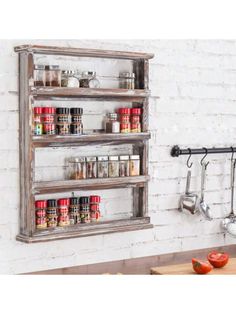 an old wooden spice rack is hanging on the wall