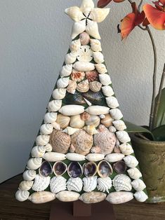 a christmas tree made out of shells and seashells