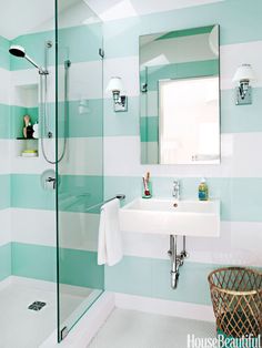 a bathroom with blue and white striped walls