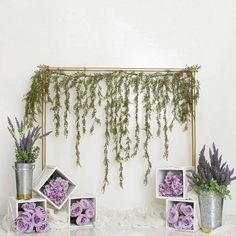 purple flowers and greenery are arranged on display