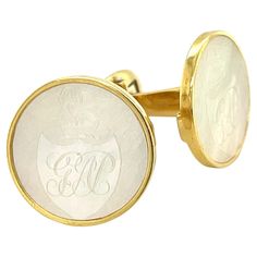 Custom-made cufflinks - for the man who has (almost) everything! These handmade 18k yellow gold cufflinks feature a beautiful pair of mother-of-pearl antique gaming counters that were originally carved in China in the 1800's. Hand-carved gaming counters were commissioned by the British and used as gambling chips the way poker chips are used in the United States. This particular pair of 19mm rounds were cut from fine quality chips that have excellent luster and pearlescence and show a family crest with the initials, "GAP." These cufflinks were handcrafted in 18k yellow gold with custom-made bezels and an oval mechanism that has been hand engraved with an ornamental leaf pattern and an elegant textured finish. The cufflinks measure 3/4" in diameter. The perfect finishing touch for a gentlema Gambling Chips, Gold Cufflinks, Poker Chips, Mother Pearl, Family Crest, Cuff Links, Hand Engraving, Leaf Pattern, Poker