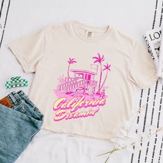 Looking for a cute versatile top to wear? Make sure to grab one of our Graphic tees! This soft and comfortable graphic tee is the perfect top for any outfit. It can be paired with biker shorts, jeans, or even a simple skirt/dress! This tee is true-to-size, so be sure to order your regular t-shirt size! If you are looking for a more oversized look, make sure to size up! Simple Skirt, California Dreamin', Cropped Tee, Shorts Jeans, Skirt Dress, Crop Tshirt, Biker Shorts, Crop Tee, Summer Women