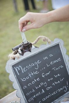 someone is holding a bottle in front of a sign that says message to another person