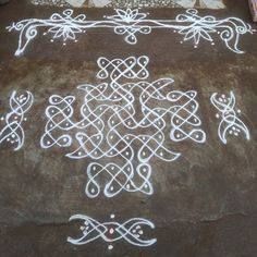 an intricately designed bed spread with white paint on it