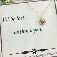 a necklace with a compass charm on it that says i'd be lost without you