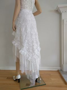 "Unique, bohemian high- low style wrap skirt. Made from white 3D lace and tulle with multi lace/tulle raffles. 40\"- 47\" across plus long lace ties and to the wrap and overlap 25\" to 35\" waist and it can easily fit up to 45\"- 46\" hips.  The V hemline length is 30\" at the front and 49\" at the back. Or this skirt can be make with your waist, hips and length measurements.  Waist Sizing: S-4-6, Waist: 25.5\"-26.5\", Hip: 36-37\"  M-8-10, Waist:  28\"-29\", Hip: 38-39\" L-12-14, Waist: 30-32\" Summer Wedding Skirt With Ruffles, Spring Wedding Maxi Skirt With Ruffles, Spring Wedding Skirt With Ruffles, Bohemian Ruffled Skirt For Party, Bohemian Tiered Tulle Skirt, Fitted Lace Maxi Skirt With Ruffles, Bohemian Ruffled Maxi Skirt For Party, Fitted Bohemian Skirt With Attached Cancan, Flowy Wedding Skirt With Attached Cancan