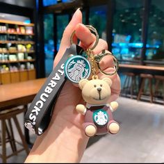 a starbucks keychain with a teddy bear on it