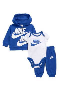 A 3-piece Nike logo set features a bodysuit, hoodie and matching joggers. 3-piece set Hoodie has attached hood, long sleeves Pants have elastic waist Bodysuit has crew neck, short sleeves, snap closure 60% cotton, 37% polyester, 3% elastane Machine wash Imported Nike Cotton Onesie For Loungewear, Nike Cotton Athleisure Sets, Cotton Hooded Sports Sets, Nike Cotton Sportswear Sets, Sporty Cotton Onesie For Playtime, Sporty Cotton Onesie For Loungewear, White Hooded Streetwear Sets, Nike White Long Sleeve Set, Sporty Cotton Long Sleeve Onesie