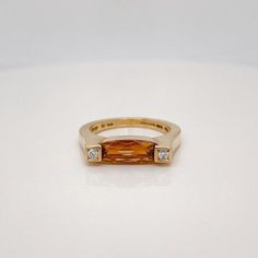 A very fine signed modernist cocktail ring.  Retailed by and marked for Asprey Co of London.  With an oval cut citrine gemstone set in center between two round brilliant pave set diamonds.  Simply a great Asprey Co. ring!  Date: 20th Century  Overall Condition: It is in overall good, as-pictured, used estate condition with some fine light surface scratches and other signs of expected light wear consistent with age.  Fineness: Marked 750 for gold fineness.  Marks: Marked to the interior for Aspre Modern Orange Oval Rings, Modern Yellow Gold Diamond Ring With Gemstone, Modern Topaz Ring With Center Stone In Yellow Gold, Modern Yellow Gold Topaz Ring With Center Stone, Modern Formal Hallmarked Topaz Ring, Modern Orange Gemstone Rings, Modern Gold Ring With Topaz, Modern Oval Topaz Ring For Formal Occasions, Modern 14k Gold Topaz Ring