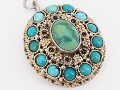 antique sterling pendant weight 16.5 grams length 30mm good antique condition; some wear not marked but has been tested and is guaranteed follow me on instagram @mindilynjewelry Antique Hallmarked Turquoise Jewelry, Ornate Turquoise Jewelry For Collectors, Turquoise Medallion Locket Jewelry, Antique Turquoise Engraved Jewelry, Antique Engraved Turquoise Jewelry, Engraved Turquoise Pendant Necklace, Antique Turquoise Cabochon Jewelry, Turquoise Round Pendant Locket Jewelry, Antique Turquoise Pendant Necklace