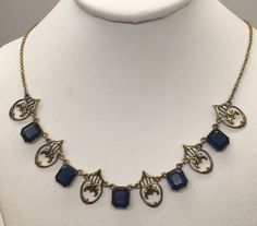 "Beautiful antique victorian Art Deco gold filled with royal blue sapphire necklace cute and dainty good pre-owned condition measures 16\" length." Blue Medieval Necklace, Antique Sapphire Necklace, Antique Blue Necklaces For Formal Occasions, Antique Blue Filigree Necklace, Victorian Blue Filigree Necklace, Blue Victorian Necklace For Formal Occasions, Victorian Blue Necklaces For Formal Occasions, Victorian Style Blue Necklaces For Formal Occasions, Blue Victorian Jewelry With Vintage Charm