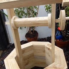 a wooden planter sitting in the middle of a garden