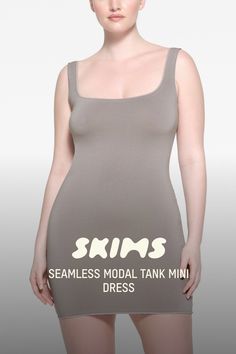 A boost to your comfort and curves. This hot mini dress flatters your figure with its super stretchy fabric and fitted silhouette. Feels ultra-soft and lightweight for indoor and outdoor comfort on warmer days. Features chic tonal edges at the wide scoop neck, armholes, and hem. Fits true to size. | SKIMS Tank Mini Dress | Grey | 4X/5X | Seamless Modal Hot Mini Dress, Mini Dress Hot, Outdoor Comfort, Mini Tank Dress, Fitted Silhouette, Gray Dress, Stretchy Fabric, Scoop Neck, Mini Dress