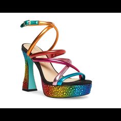 Color: Multicolor Get A Grand Entrance Wherever You Go With The Bright And Upbeat Attitude Of The Maeve Platform Sandal By Betsey Johnson. Featuring A Strappy Rainbow Hued Upper, This Pump Boasts A Towering Platform Heel And Flared Block Heel To Take Your Glam Appeal Sky High While The Sparkling Rhinestone Embellishment Instills Bling Looks. Features Synthetic Upper Adjustable Buckle-Strap Closure Square Open Toe Synthetic Lining 4.75" Covered Heel Rubber Sole Imported Bold Platform Sandals For Party, Bold Round Toe Sandals For Party, Bold High Heel Synthetic Sandals, Bold Round Toe Party Sandals, Bold Party Sandals With Round Toe, Bold Sandals With Heel And Ankle Strap, Bold High Heel Sandals For Party, Bold Synthetic Sandals For Party, Bold Block Heel Sandals For Party