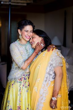 two women are hugging each other and smiling